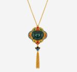 Verdant Majesty Cold Enamel Necklace with dark green center, multicolored floral frame, and golden tassel