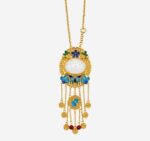 Azure Cloud Medallion Cold Enamel Necklace with oval white jade, blue cloud motifs, and seven golden tassels