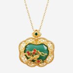 Verdant Magpie Cold Enamel Necklace with gold bird and red plum blossoms on a dark green background