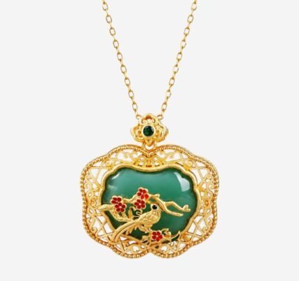 Verdant Magpie Cold Enamel Necklace with gold bird and red plum blossoms on a dark green background