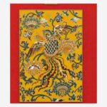 Close-up detail of Chinese silk brocade phoenix and floral pattern